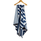 Navy blue and white stripped towel hanging on a coat hanger.